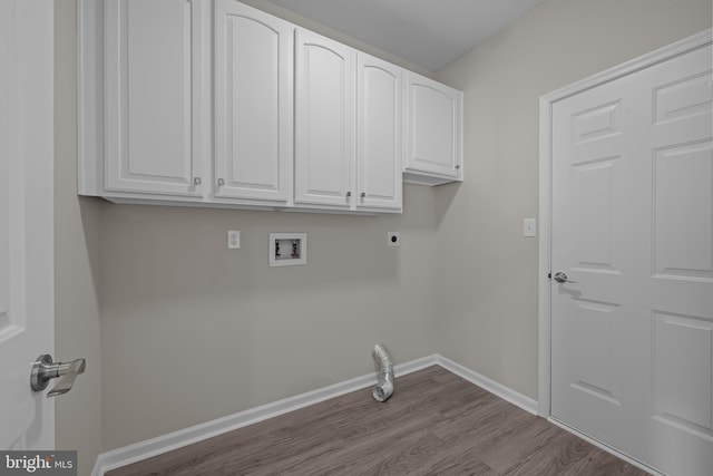 clothes washing area with electric dryer hookup, hookup for a washing machine, cabinets, and light hardwood / wood-style floors