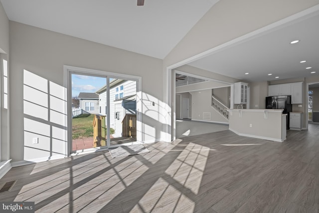 interior space with dark hardwood / wood-style flooring and lofted ceiling