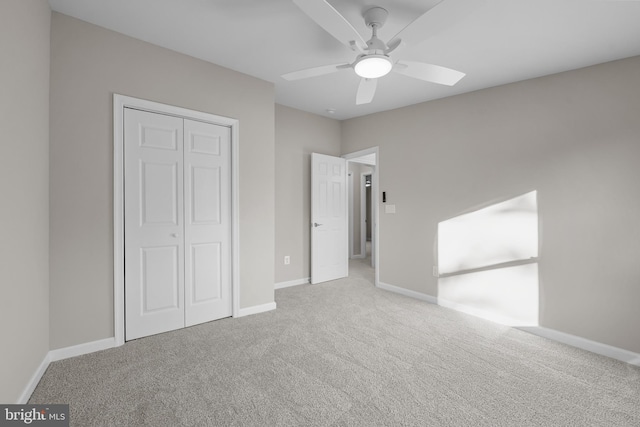 unfurnished bedroom featuring ceiling fan, a closet, and carpet