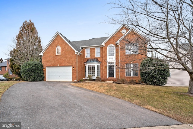 view of property with a front yard and a garage