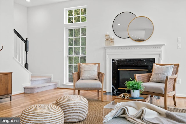 living area with a fireplace and light hardwood / wood-style flooring