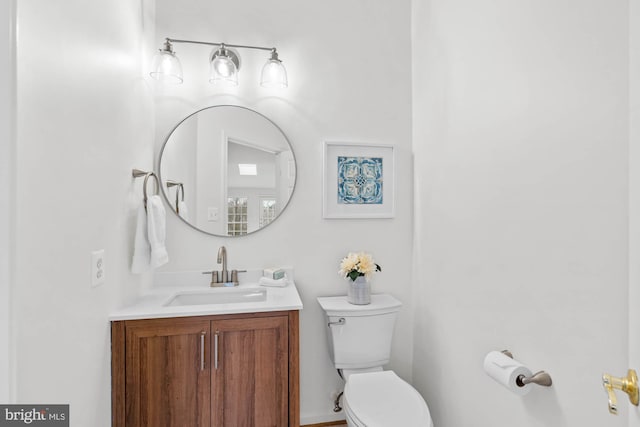 bathroom with toilet and vanity