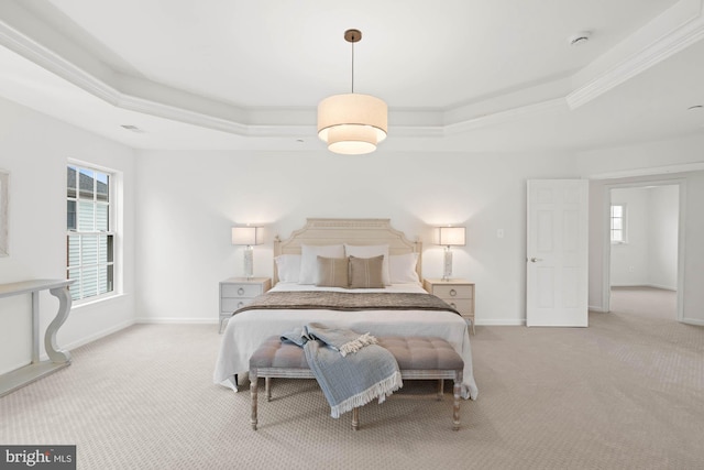 bedroom featuring a tray ceiling, light carpet, and ornamental molding