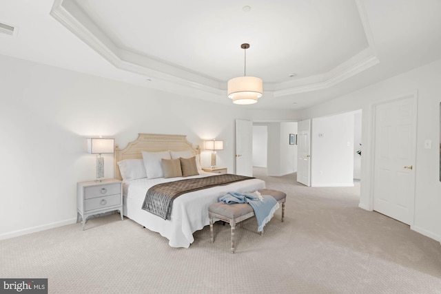 carpeted bedroom with a raised ceiling