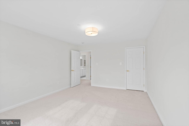 unfurnished bedroom featuring light carpet