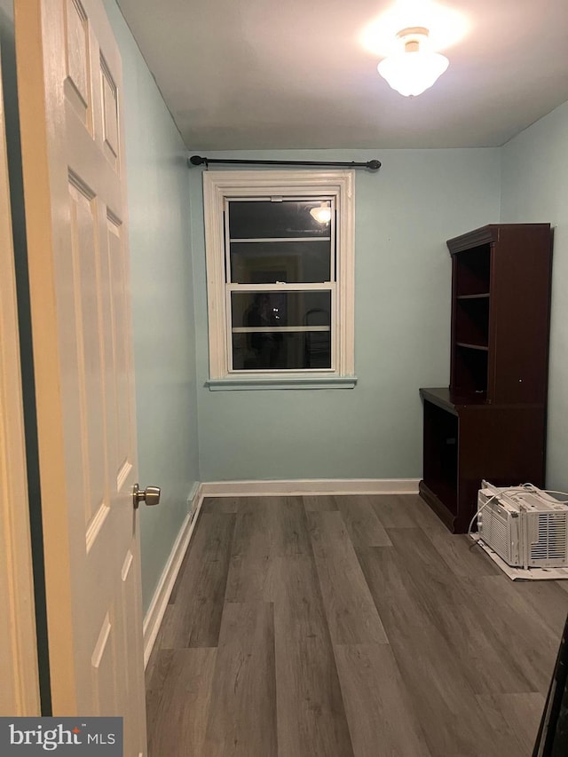 unfurnished room with dark hardwood / wood-style flooring