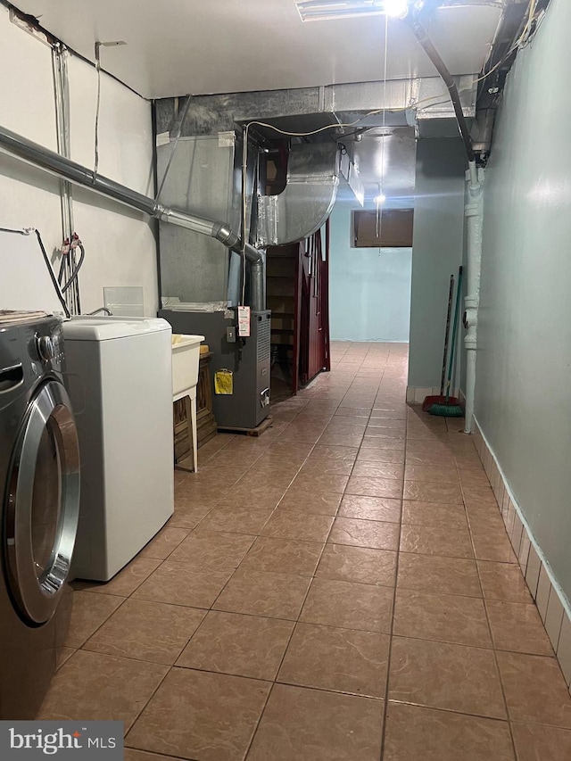 clothes washing area with washer and clothes dryer