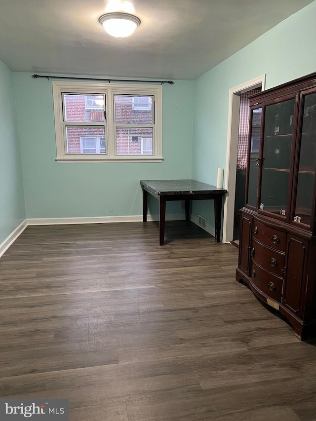 spare room featuring dark hardwood / wood-style flooring