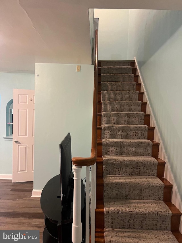 stairway with hardwood / wood-style flooring