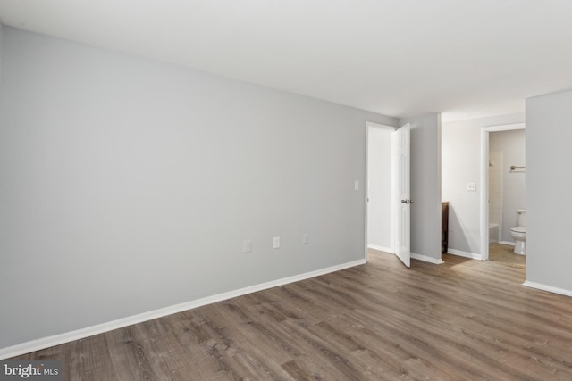 unfurnished room with wood-type flooring