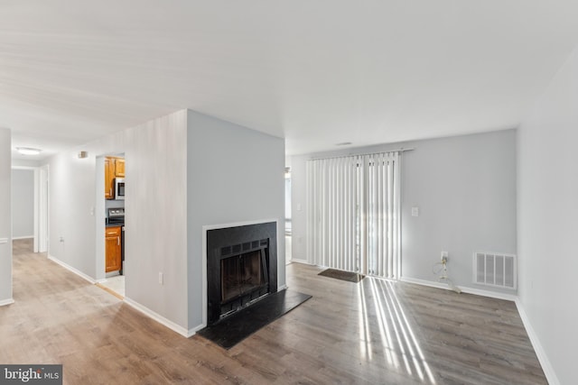 unfurnished living room with light wood-type flooring