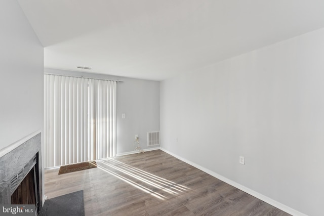 unfurnished living room featuring wood-type flooring