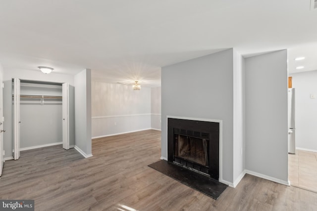 unfurnished living room featuring hardwood / wood-style flooring