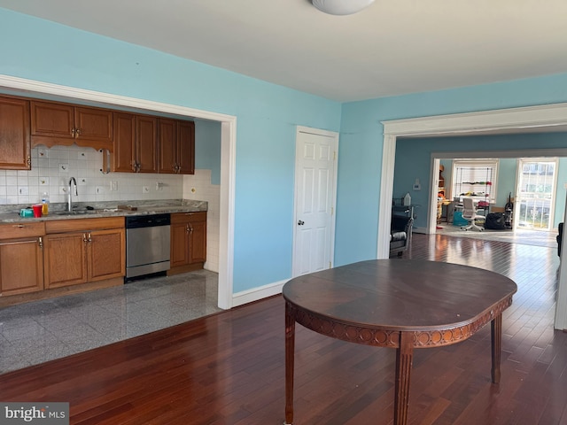 kitchen featuring tasteful backsplash, stainless steel dishwasher, and sink