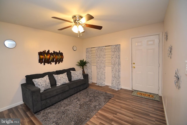 living room featuring dark hardwood / wood-style flooring and ceiling fan