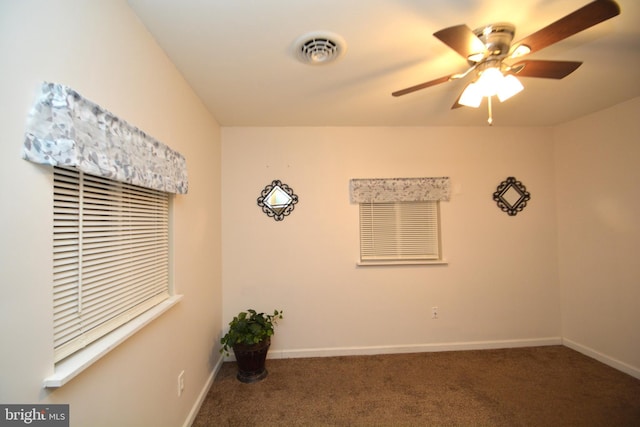 carpeted spare room featuring ceiling fan