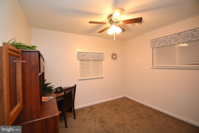 carpeted home office featuring ceiling fan