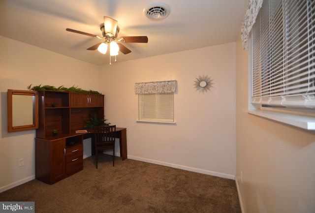 carpeted office space featuring ceiling fan