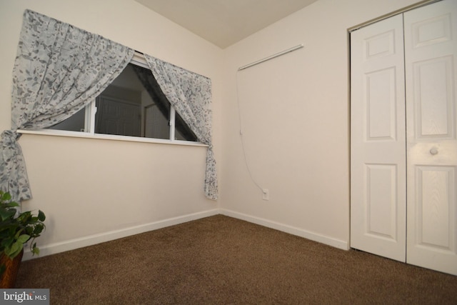 interior space featuring dark colored carpet