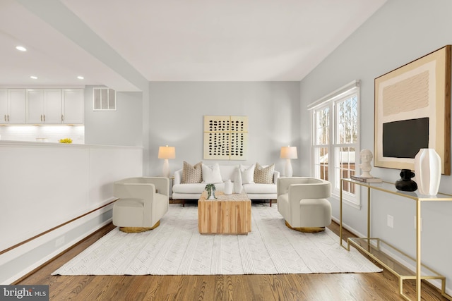 living room with a baseboard radiator and light hardwood / wood-style flooring