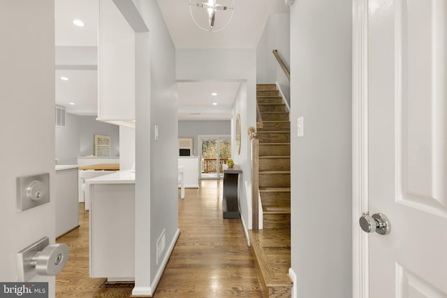 corridor with light hardwood / wood-style floors