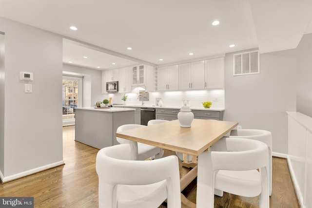 dining room featuring sink and light hardwood / wood-style flooring