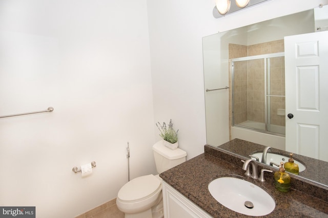 bathroom with walk in shower, vanity, and toilet