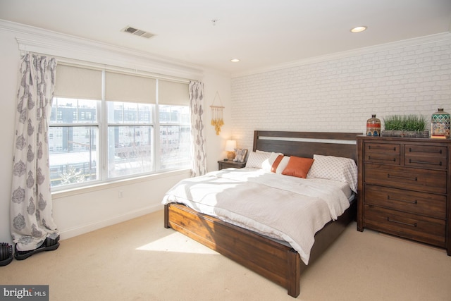 carpeted bedroom featuring brick wall and ornamental molding