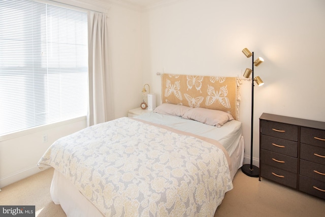 carpeted bedroom with ornamental molding