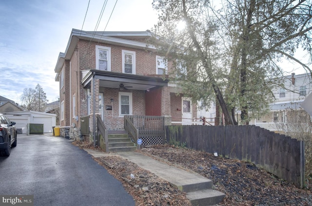 view of front facade with covered porch, a garage, and an outdoor structure