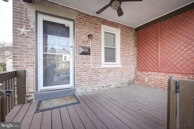 wooden terrace featuring ceiling fan and a porch