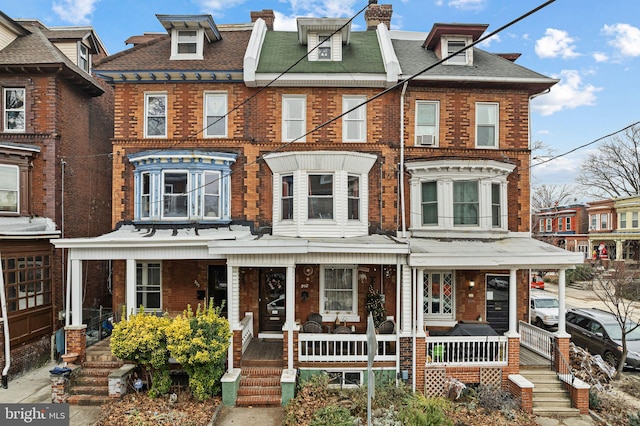 townhome / multi-family property featuring a porch