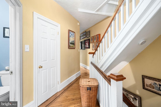 entryway with a textured ceiling and light hardwood / wood-style flooring