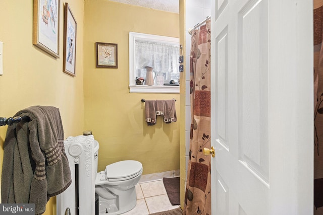 bathroom with toilet and tile patterned floors