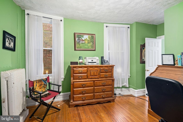 office space featuring hardwood / wood-style flooring and a textured ceiling