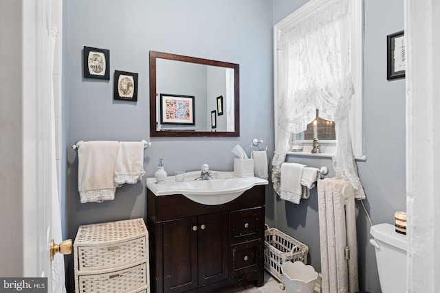 bathroom featuring radiator heating unit, vanity, and toilet