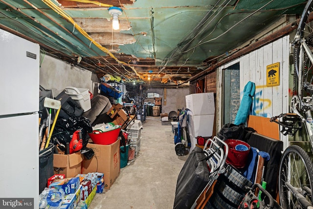 basement featuring white fridge