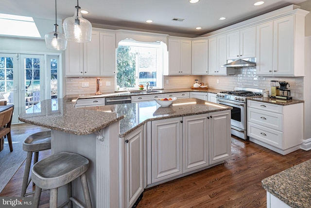 kitchen featuring a skylight, white cabinetry, and appliances with stainless steel finishes