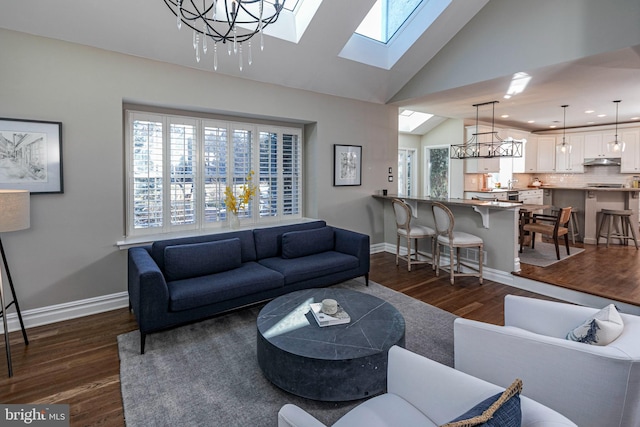 living room featuring vaulted ceiling, dark hardwood / wood-style floors, and a notable chandelier