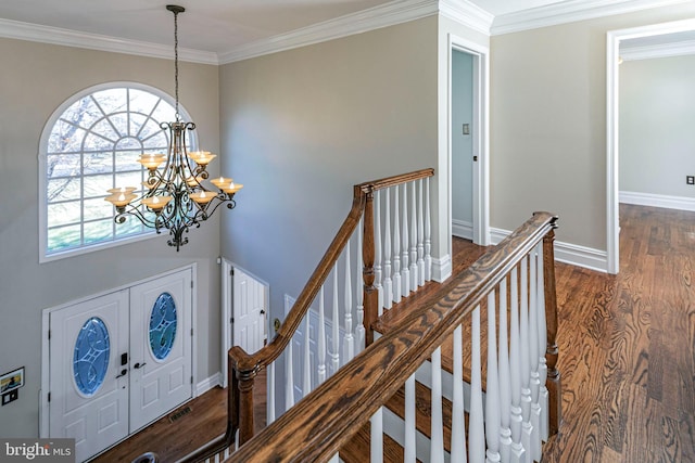 entryway featuring crown molding, a chandelier, and dark hardwood / wood-style floors