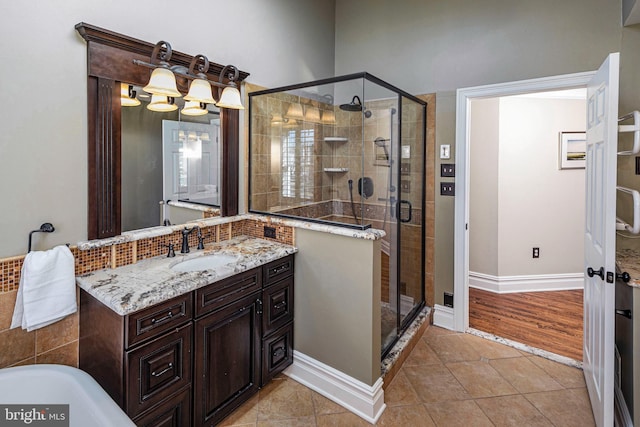 bathroom featuring tile patterned flooring, vanity, and walk in shower