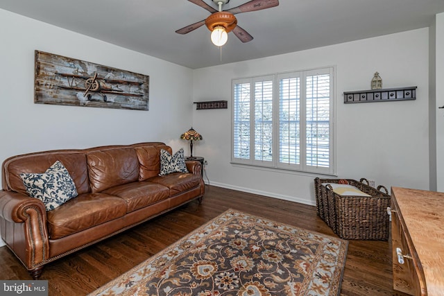 living room with ceiling fan and dark hardwood / wood-style flooring