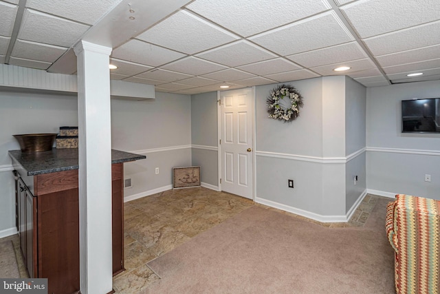 basement featuring a paneled ceiling