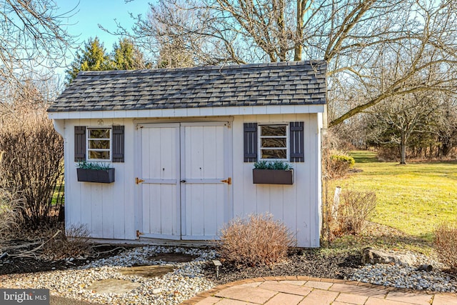 view of outbuilding with a yard