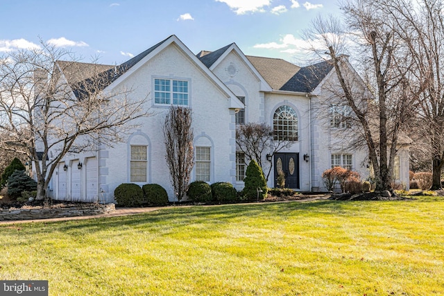 view of front of home featuring a front yard and a garage