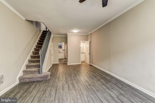 interior space featuring hardwood / wood-style flooring, ceiling fan, and crown molding