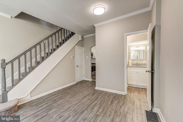 interior space featuring light hardwood / wood-style flooring and crown molding