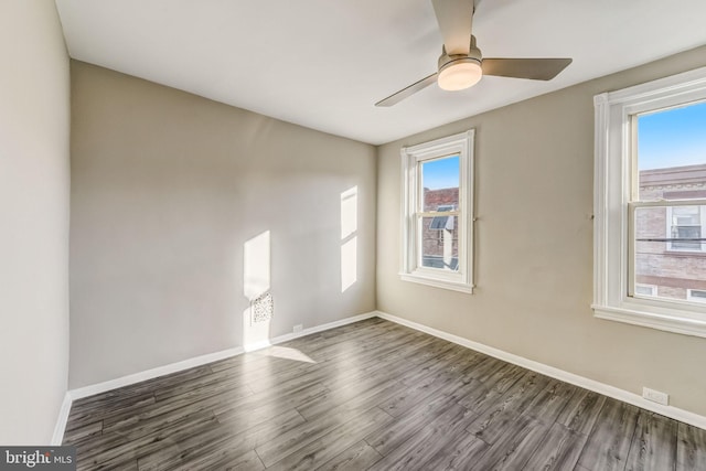 spare room with hardwood / wood-style floors, ceiling fan, and a healthy amount of sunlight