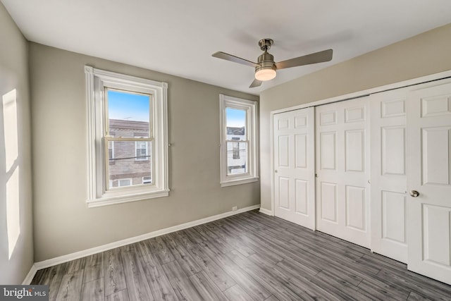 unfurnished bedroom featuring ceiling fan, a closet, and dark hardwood / wood-style floors