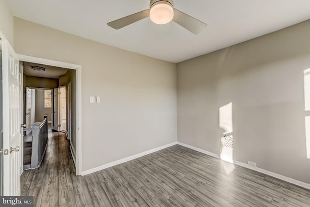 unfurnished room featuring ceiling fan and wood-type flooring